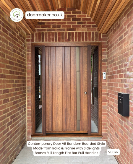contemporary front door made from iroko with sidelights and bronze pull handles